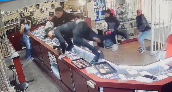 Several men can be seen on surveillance footage jumping over the jewelry store counter as they carried out the violent heist.