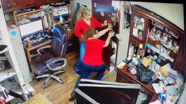 Female employees at the jewelry store could be seen in surveillance video trying to shut the door to the office of the store while the criminals tried to push their way through.
